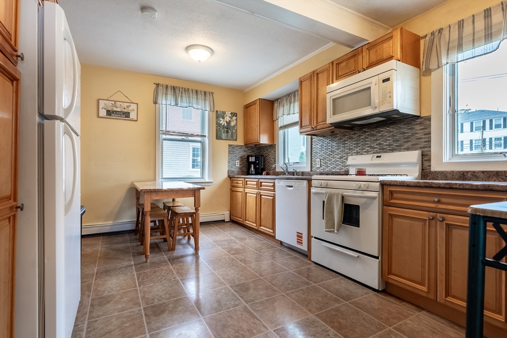 17 Middle Street Fairhaven, MA 02719 - Photo 2 of 18 a kitchen with a stove a sink and a refrigerator