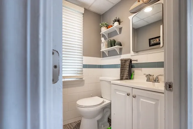 a bathroom with a sink a toilet and a mirror
