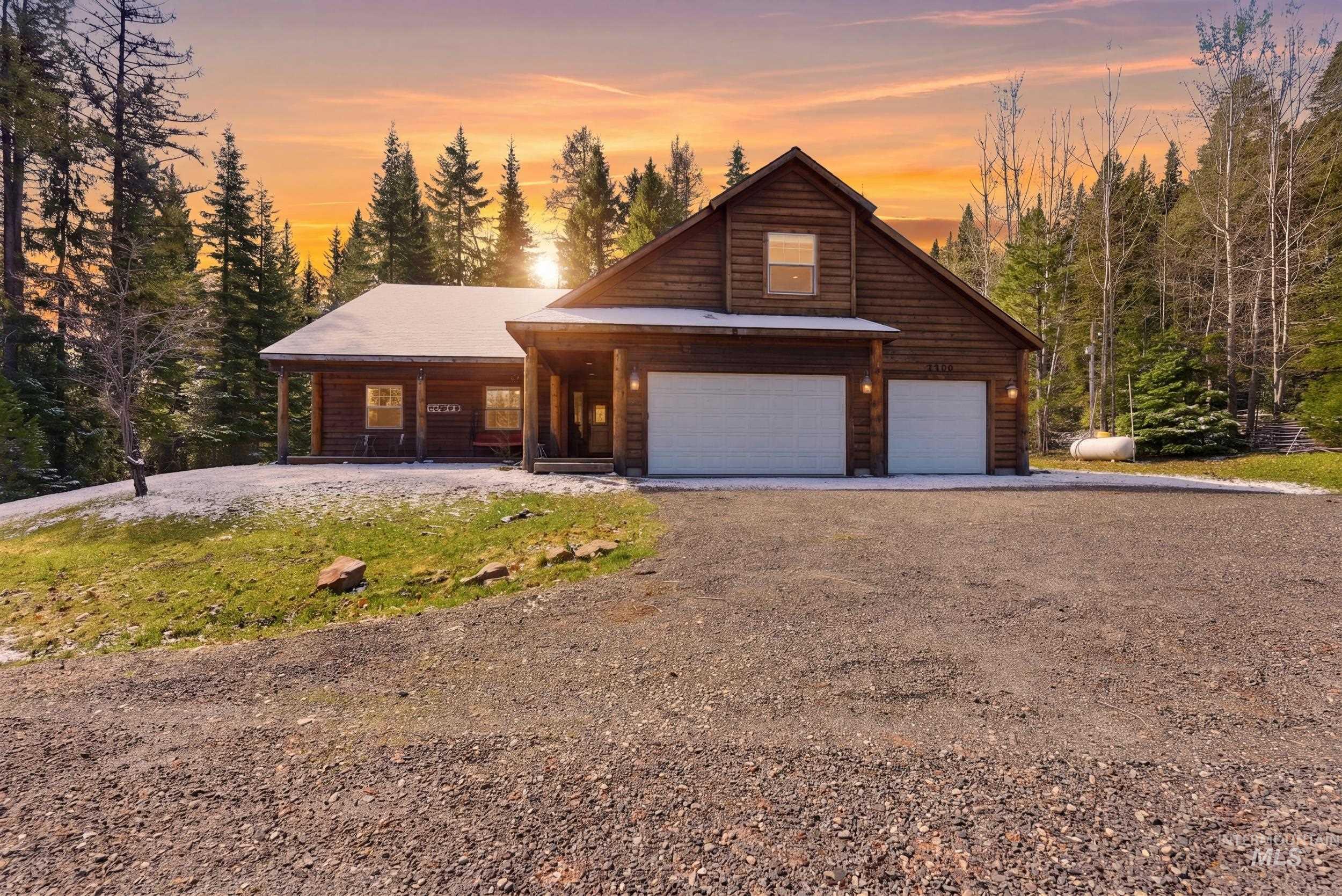 2538 West Mountain Road Donnelly, ID 83615 - Photo 1 of 50 Wood-sided residence featuring a covered front porch and a two-car garage