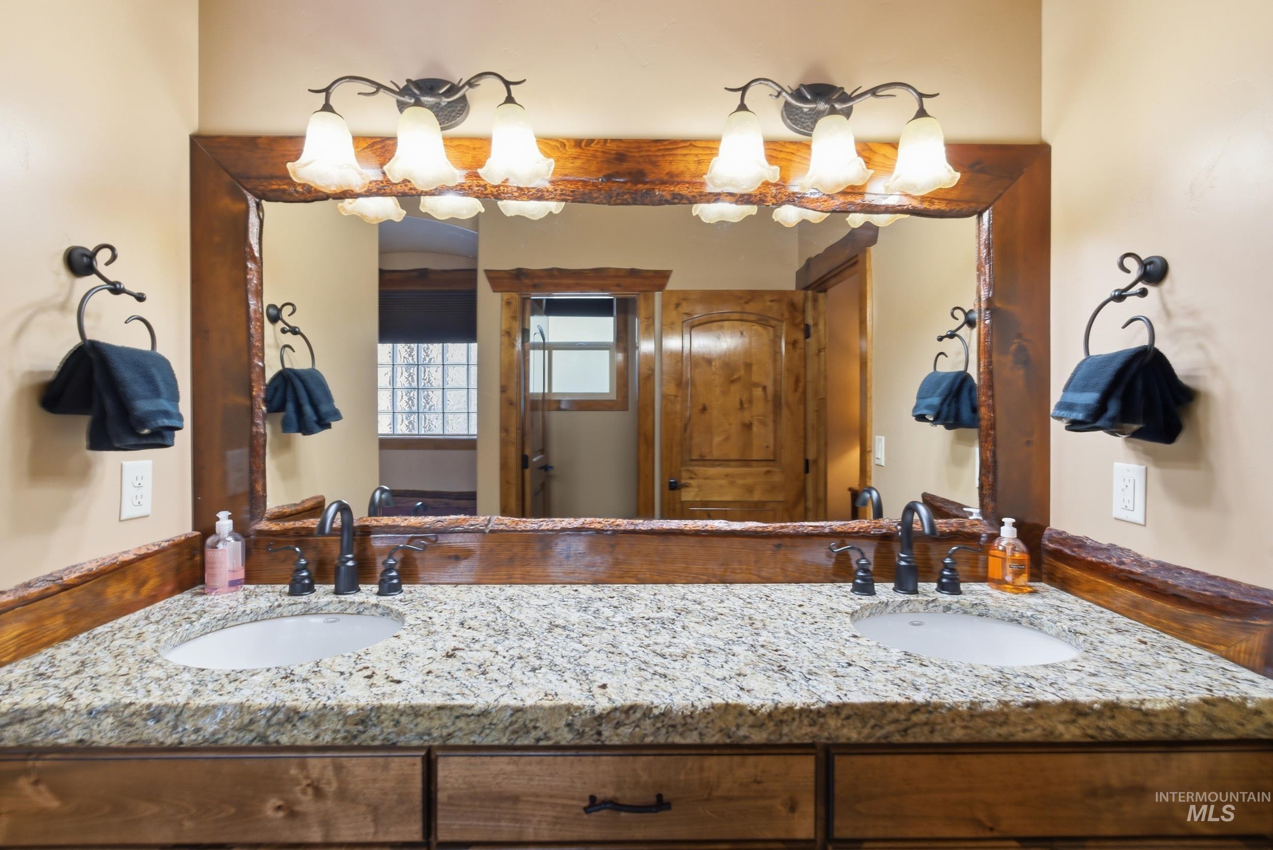 2538 West Mountain Road Donnelly, ID 83615 - Photo 16 of 50 Double vanity with an integrated countertop featuring two undermount sinks