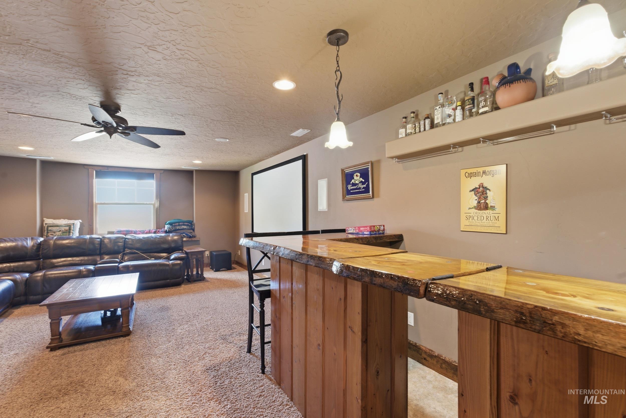 2538 West Mountain Road Donnelly, ID 83615 - Photo 25 of 50 Custom-built wood bar featuring a live-edge countertop and recessed lighting