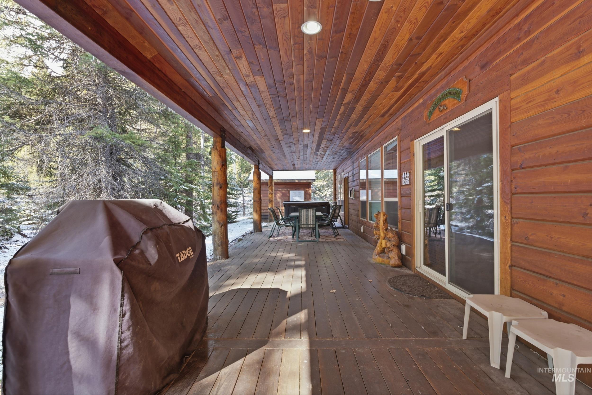 2538 West Mountain Road Donnelly, ID 83615 - Photo 27 of 50 Expansive covered porch featuring a wood-plank ceiling, recessed lighting, wood-finish siding, and multiple large windows