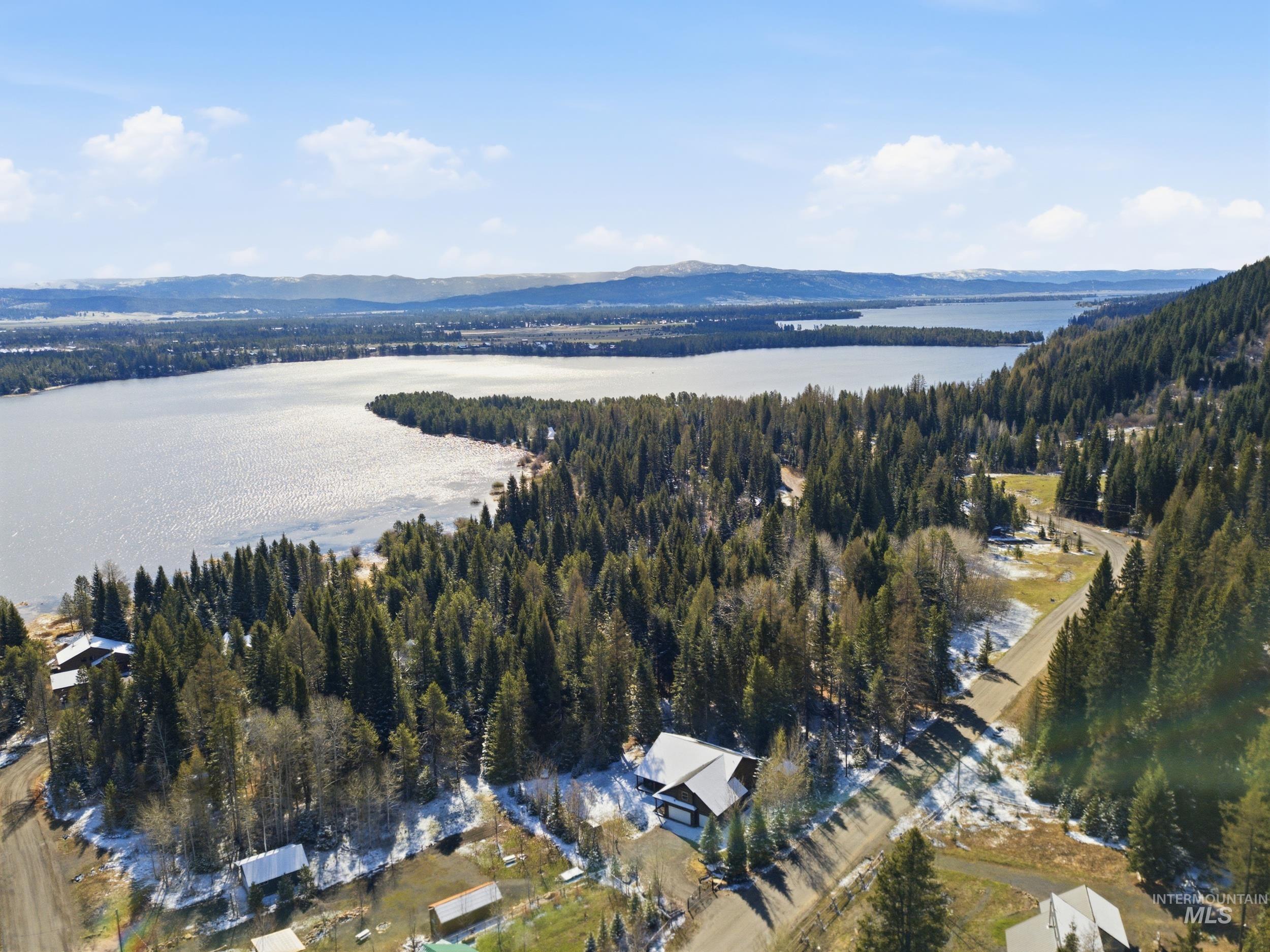 2538 West Mountain Road Donnelly, ID 83615 - Photo 48 of 50 Expansive lake and forest landscape featuring a body of water, dense evergreen trees, and distant hills