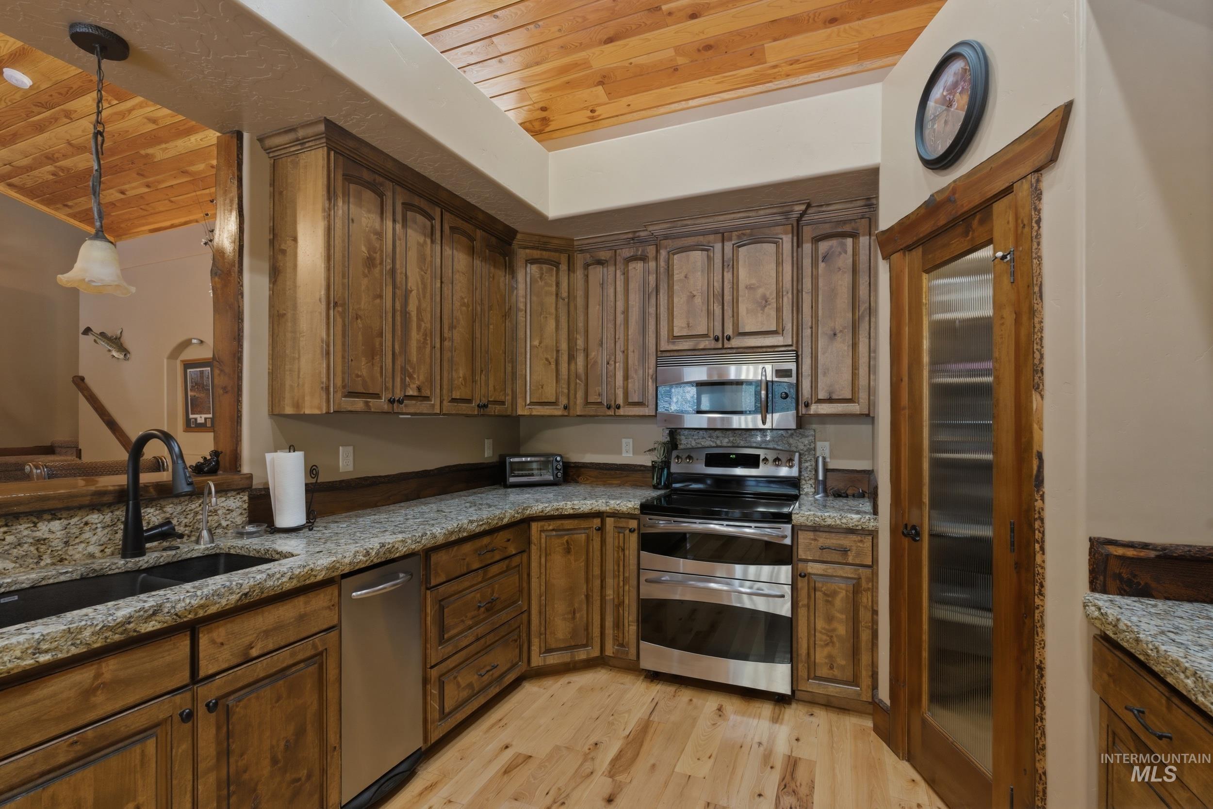 2538 West Mountain Road Donnelly, ID 83615 - Photo 10 of 50 Kitchen featuring wood-finish flooring and a wood plank ceiling
