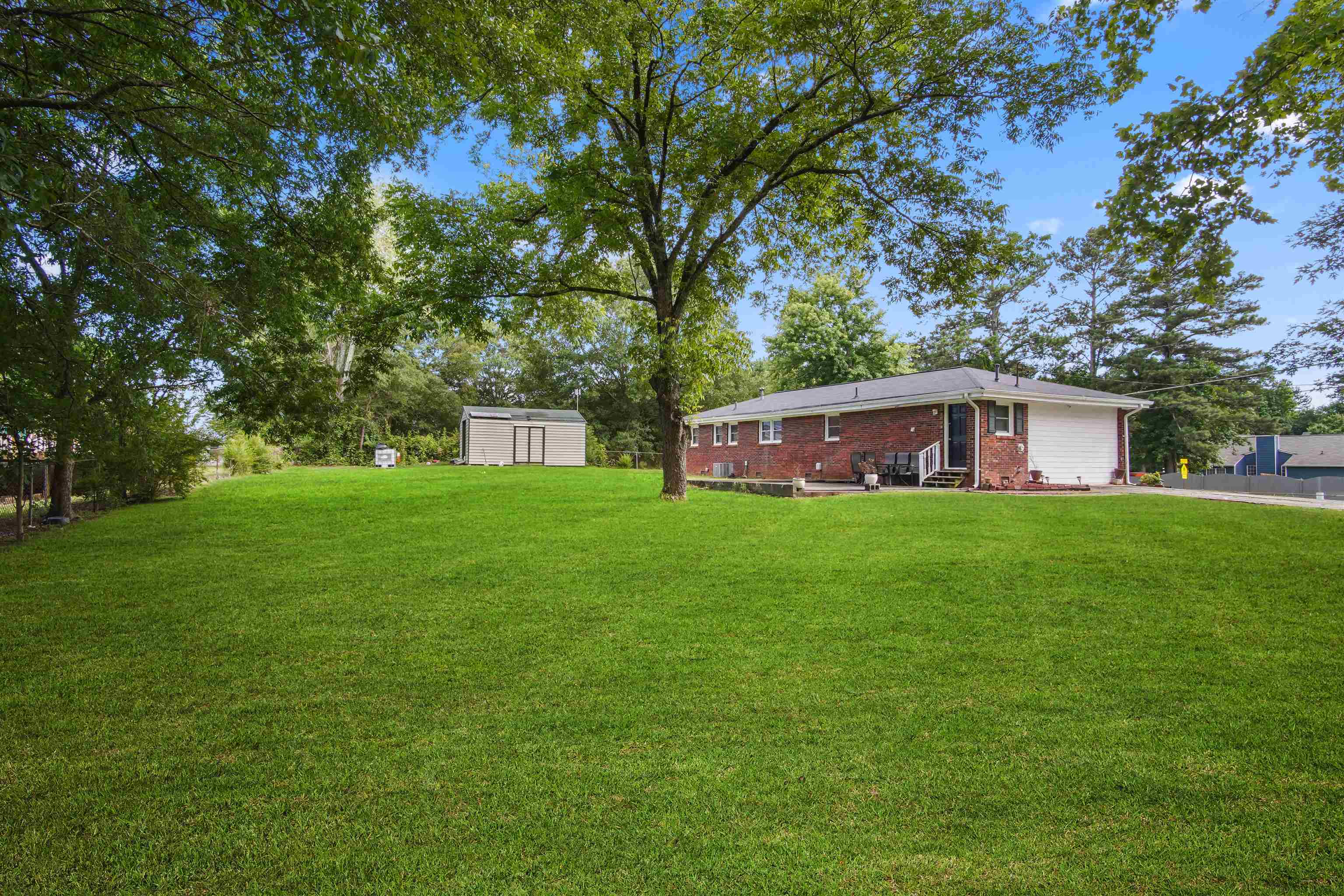 a front view of house with a garden