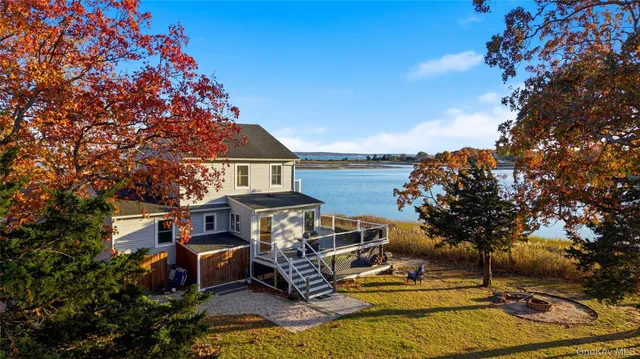 a view of a house with backyard porch and sitting area