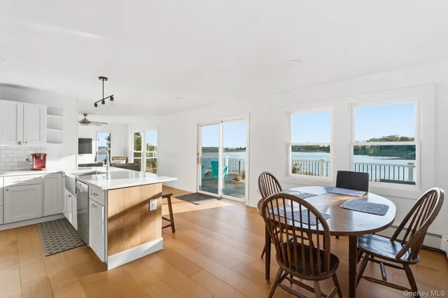 a dining room with furniture and large windows