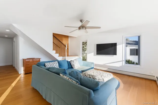 a living room with furniture and a large window with balcony view