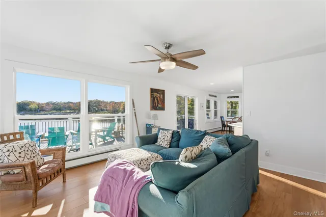 a living room with furniture and a large window with balcony view