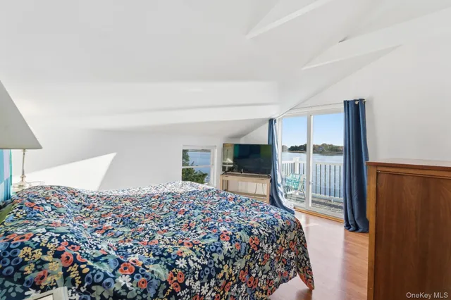 a bedroom with a large bed and a tv