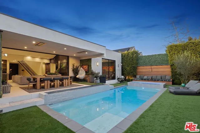 a view of a swimming pool with outdoor seating