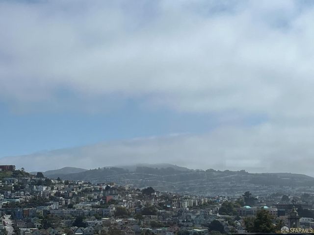 a living room with furniture a mirror and a wooden floor