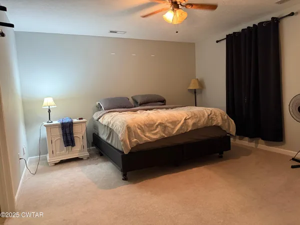 a bed room with a bed and a chair