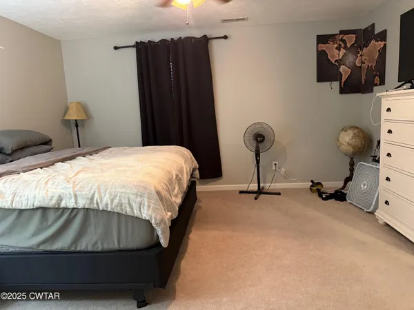 a bedroom with a bed and a table in it