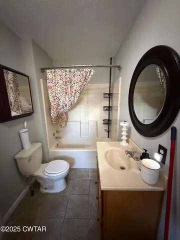 a bathroom with a sink toilet a mirror and tub