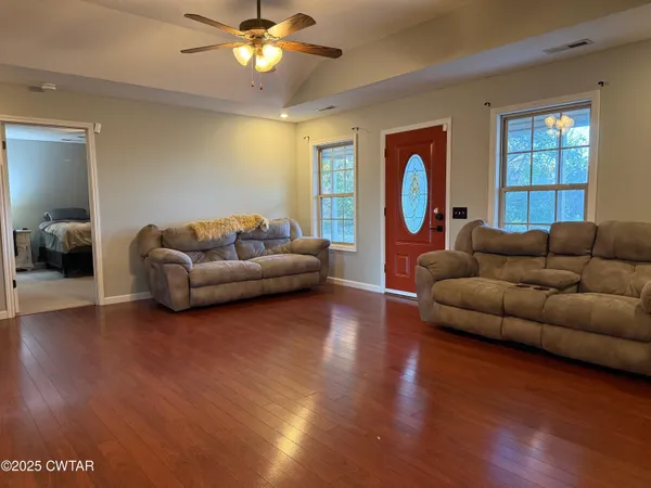 a living room with furniture and a large window