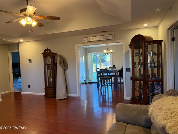 a living room with fireplace furniture and a wooden floor