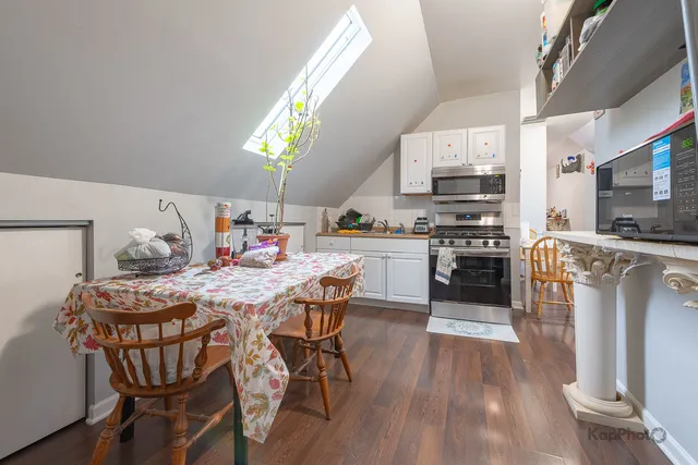 a dining room with furniture and wooden floor