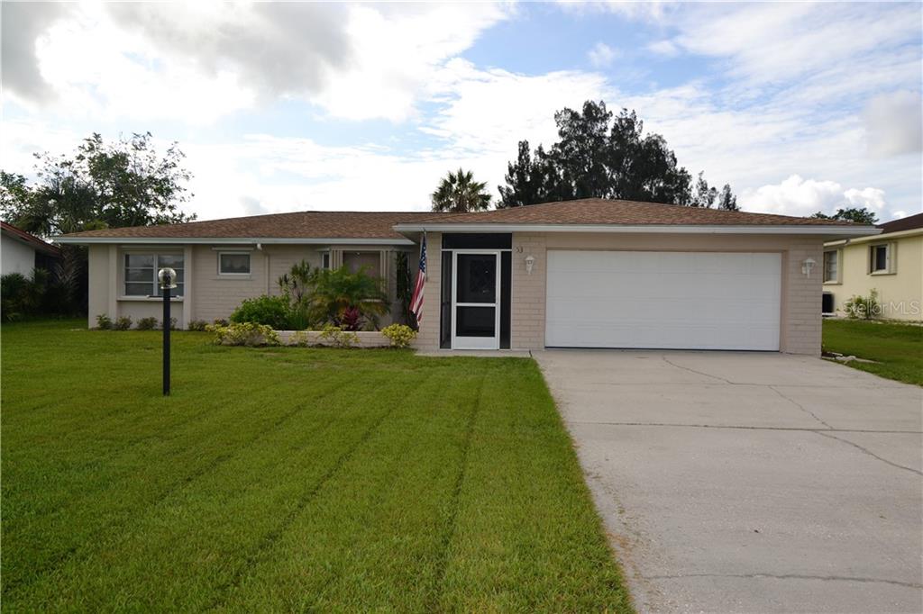 53 Caddy Road Rotonda West, FL 33947 - Photo 1 of 1 front view of house with a yard