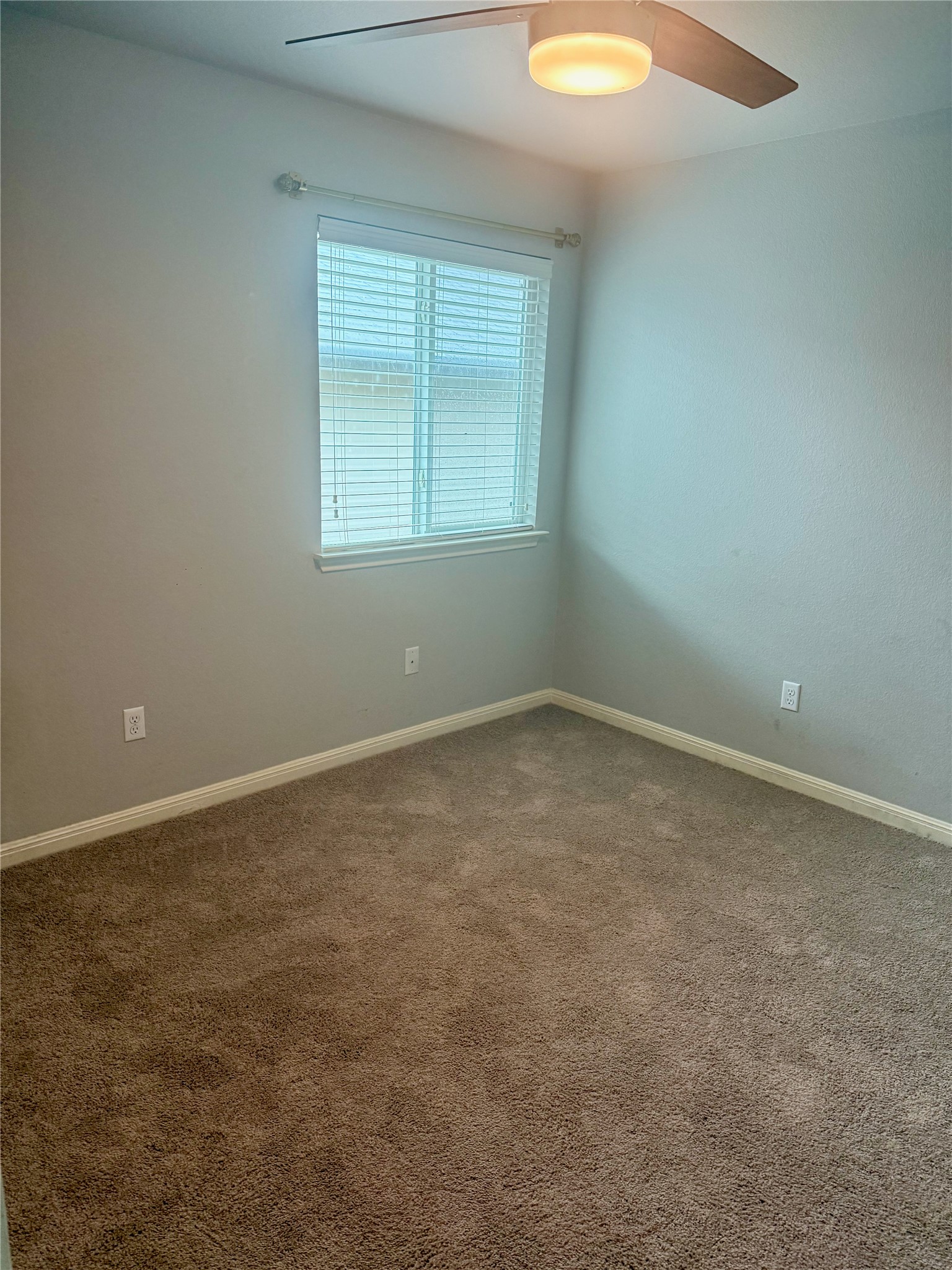 315 Nottingham Loop Kyle, TX 78640 - Photo 10 of 16 A well-lit bedroom features plush carpeting and a modern ceiling fan for ultimate comfort.
