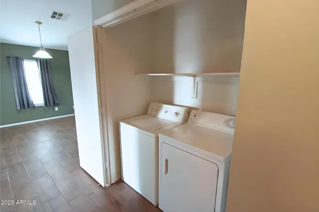a view of storage and utility room with wooden floor