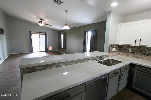 a bathroom with a granite countertop sink a large mirror and vanity