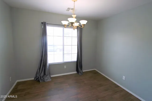 a view of wooden floor and a chandelier in a room