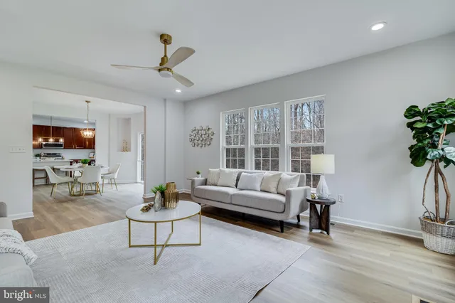 a bathroom with a toilet a sink a tub and a mirror