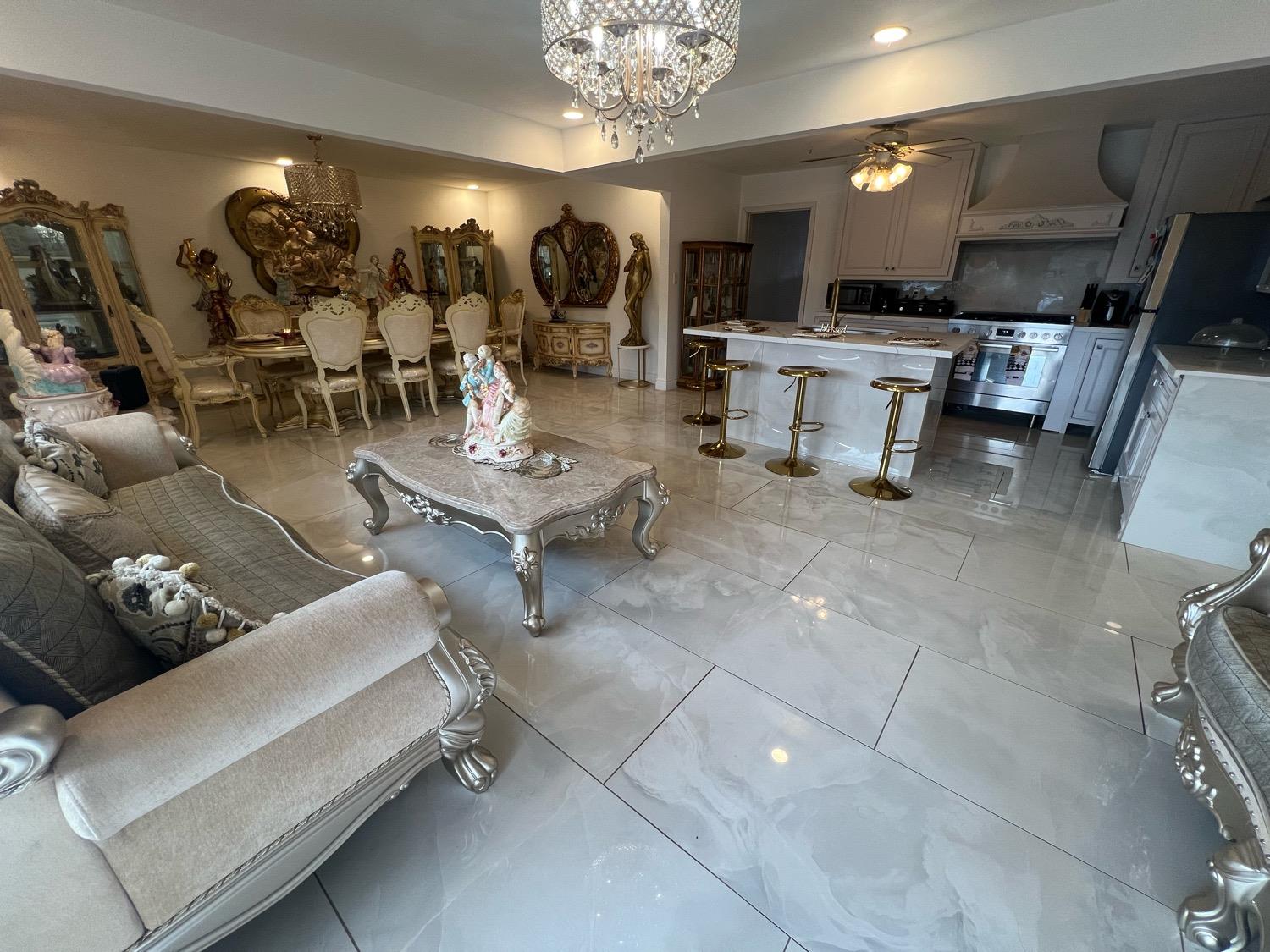 a living room with couches and a dining table with kitchen view