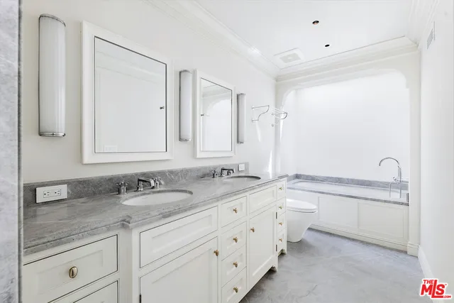 a bathroom with a granite countertop sink mirror and double
