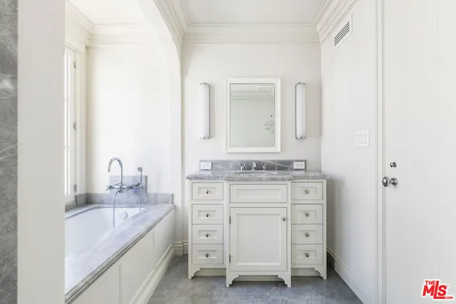 a bathroom with a granite countertop sink mirror and a