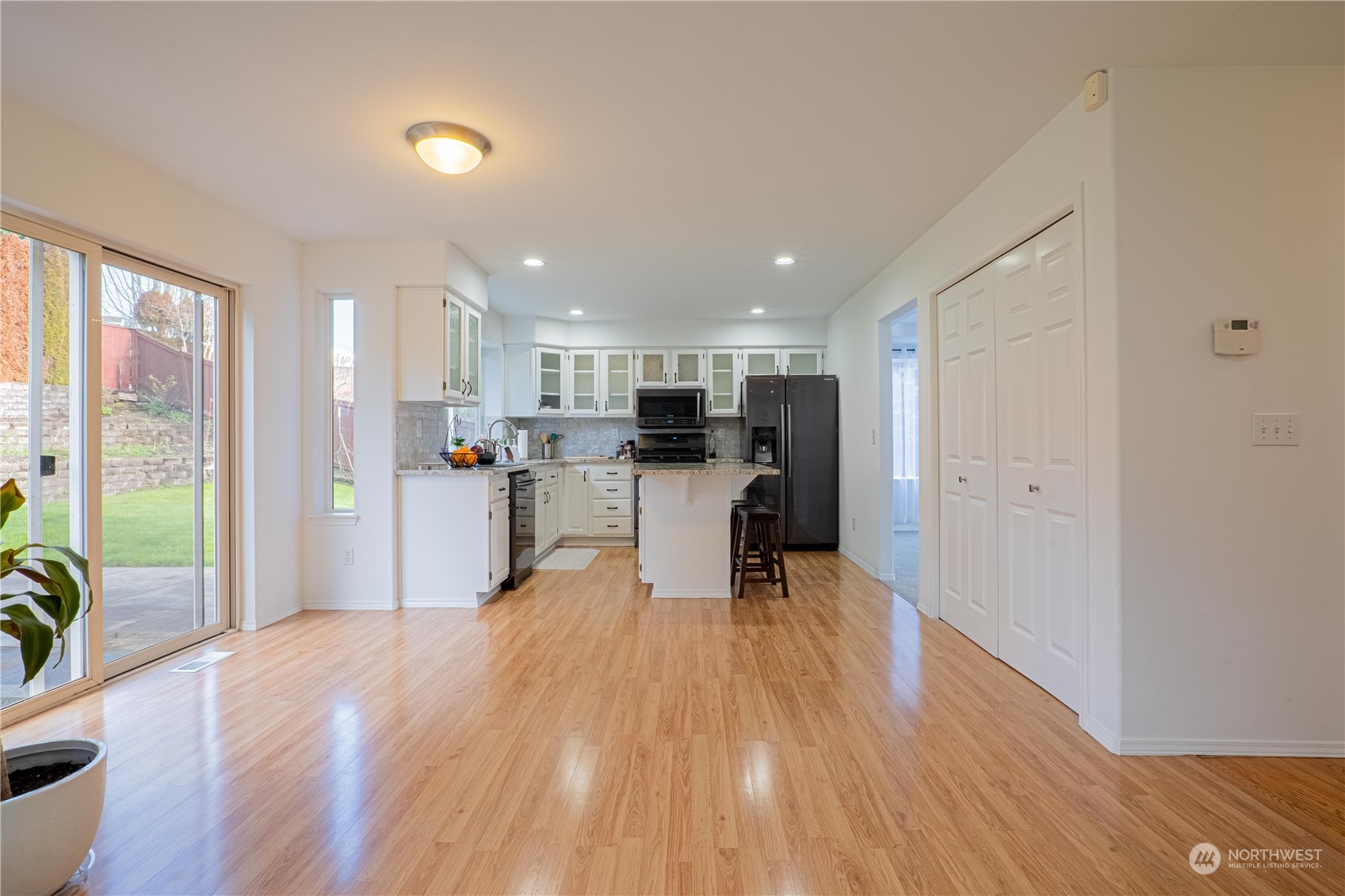 4608 Northeast 7th Place Renton, WA 98059 - Photo 16 of 38 a kitchen with a refrigerator a counter top space and a view of living room