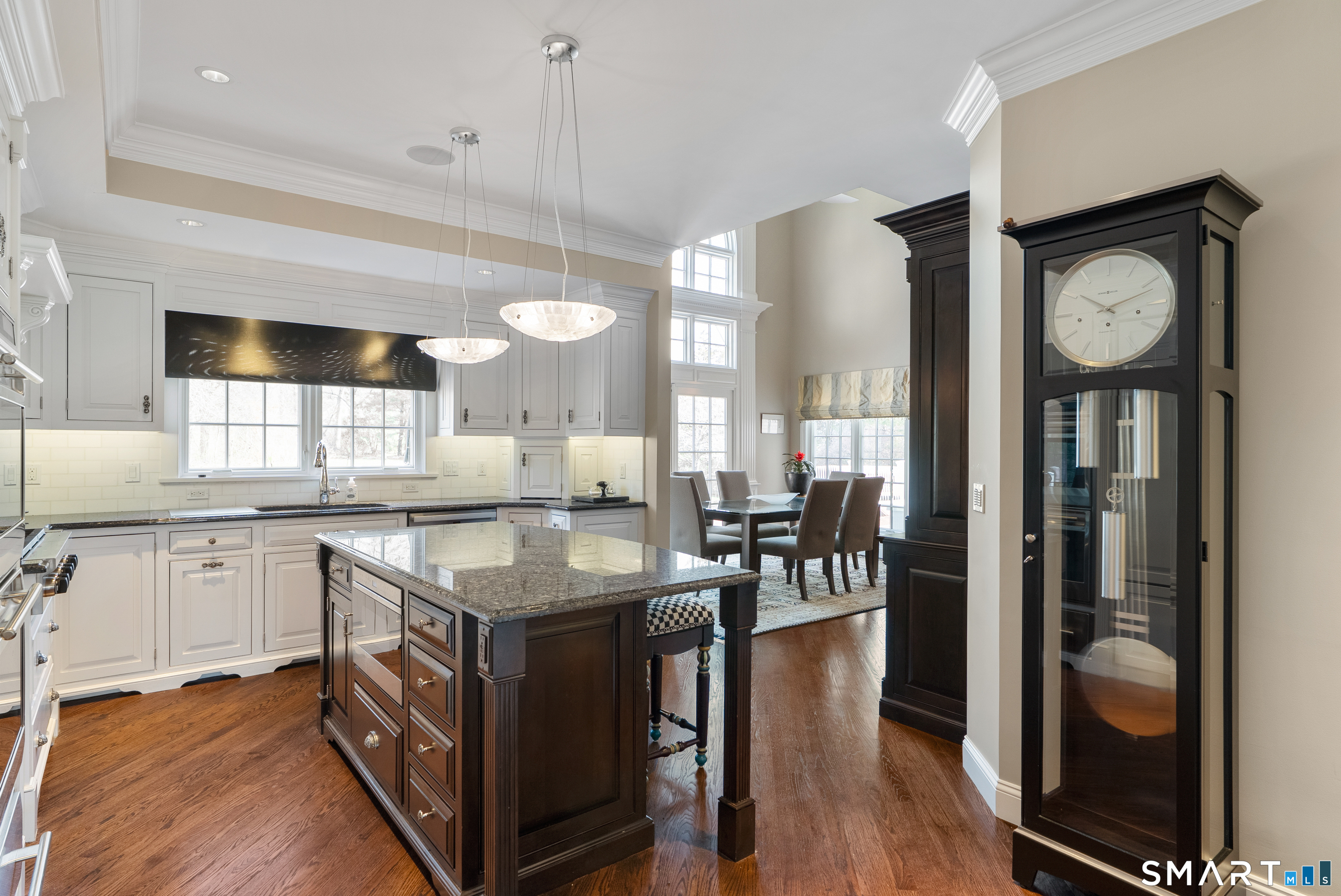 57 Thistledown Suffield, CT 06078 - Photo 11 of 39 a kitchen with granite countertop a stove a sink a dining table and chairs