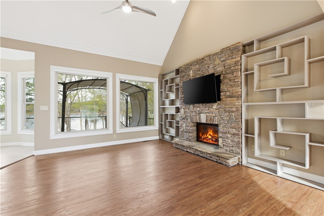 501 Capri Point Lavonia, GA 30553 - Photo 16 of 50 This airy living space features built-in shelving, a stone fireplace, and expansive windows with scenic views.