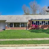 a view of an house with backyard porch and garden