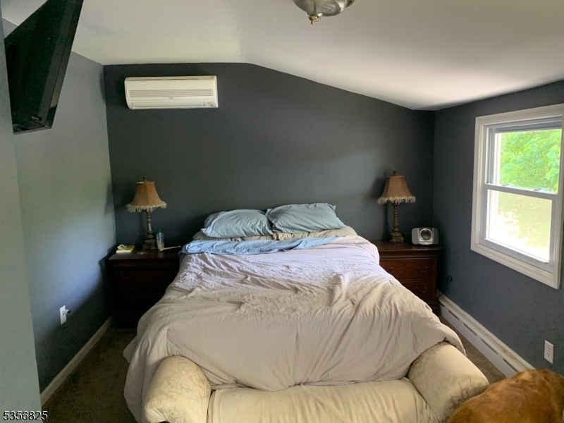 7 Shore Road Wayne, NJ 07470 - Photo 11 of 13 a bed sitting in a bedroom next to a window
