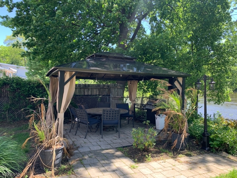 7 Shore Road Wayne, NJ 07470 - Photo 13 of 13 a view of a patio with table and chairs potted plants and large tree