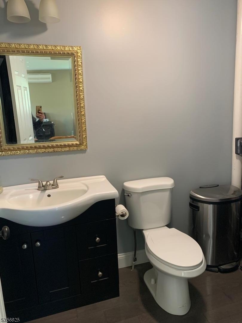 7 Shore Road Wayne, NJ 07470 - Photo 8 of 13 a bathroom with a toilet a sink and mirror