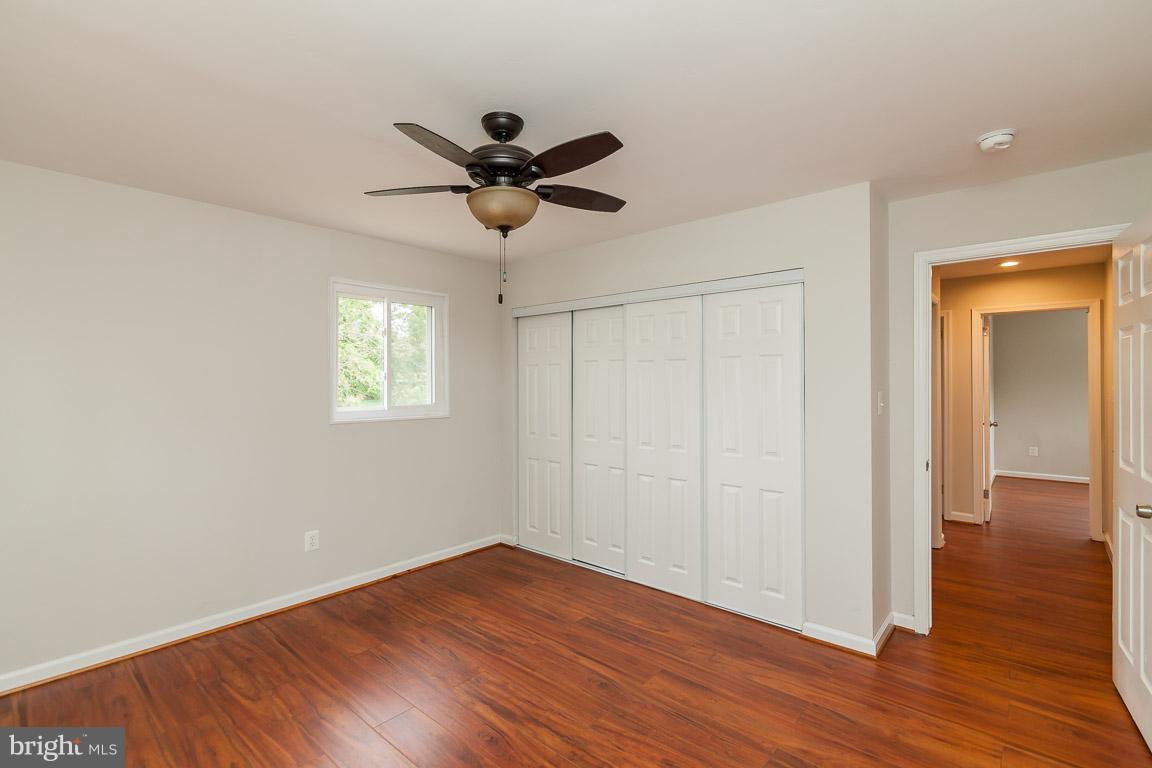 6009 Backlick Road Springfield, VA 22150 - Photo 5 of 21 an empty room with wooden floor and windows