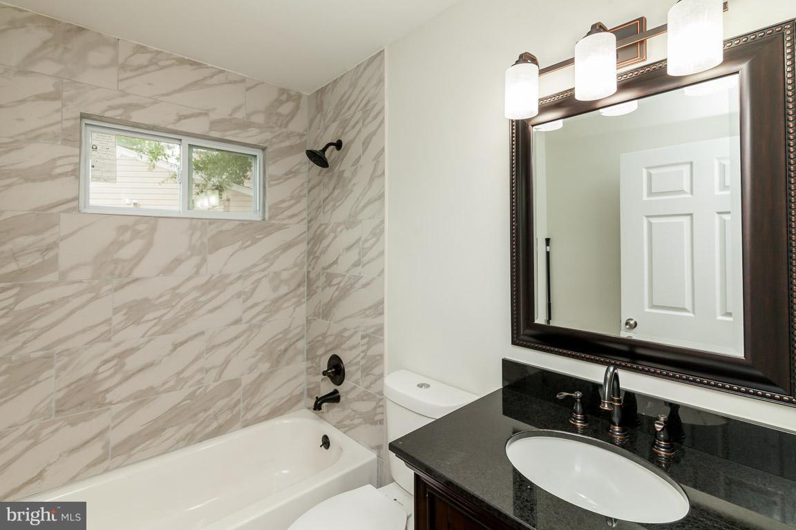 6009 Backlick Road Springfield, VA 22150 - Photo 6 of 21 a bathroom with a sink and a mirror