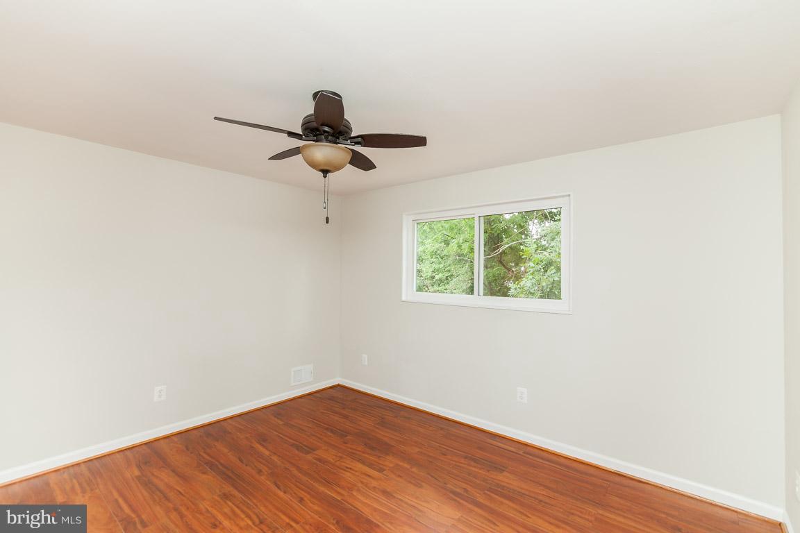 6009 Backlick Road Springfield, VA 22150 - Photo 7 of 21 a view of a room with wooden floor and window