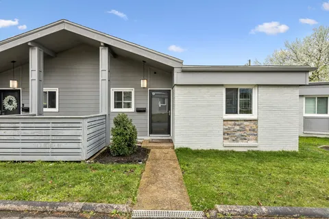a front view of a house with a garden