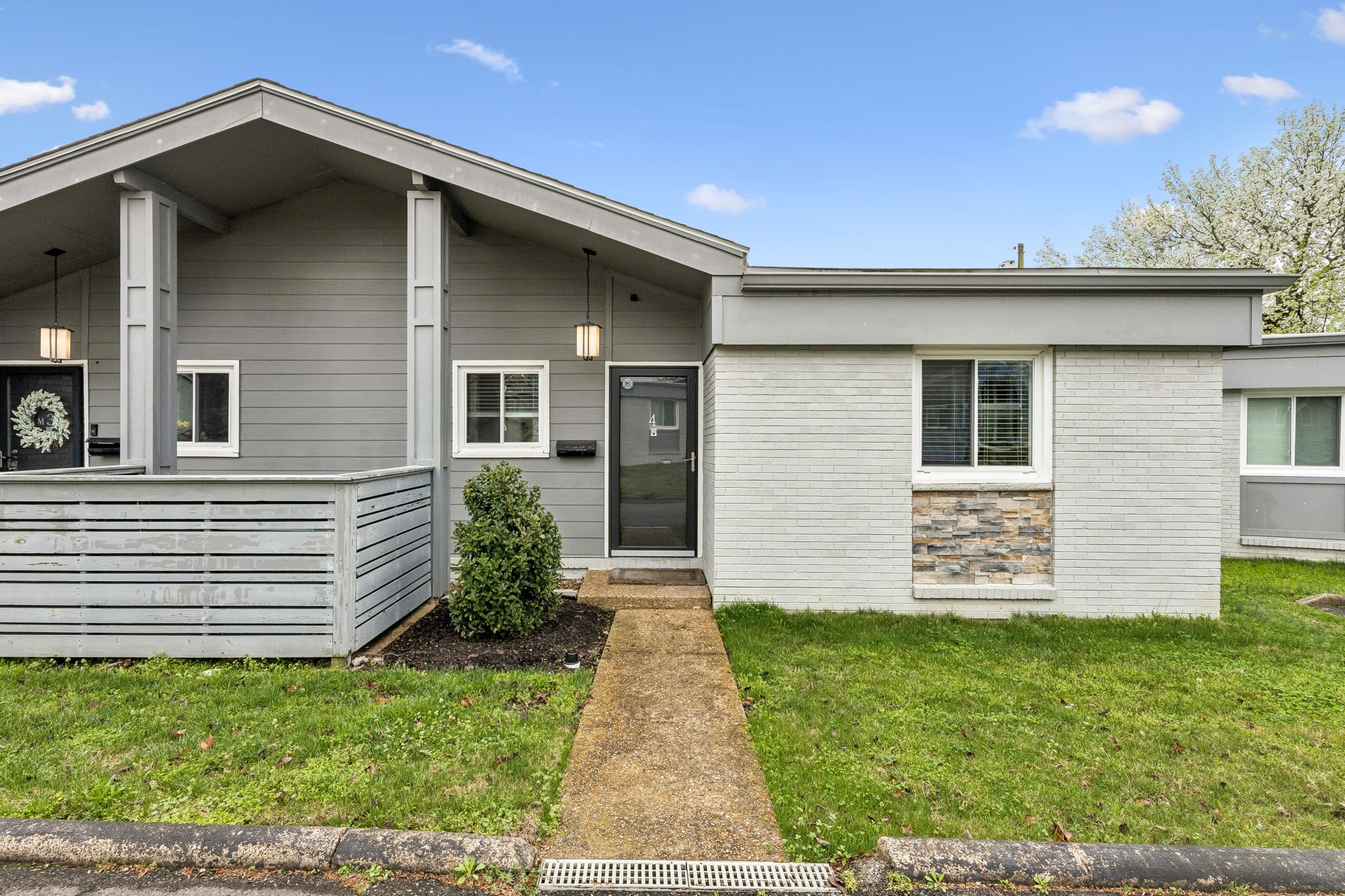 a front view of a house with a garden