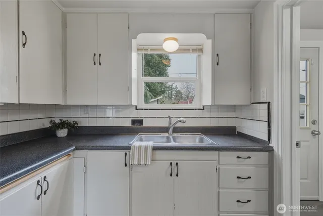 a kitchen with a sink cabinets and window