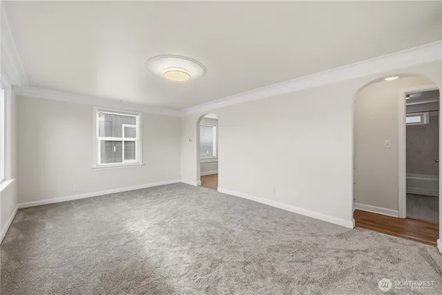 an empty room with windows and closet