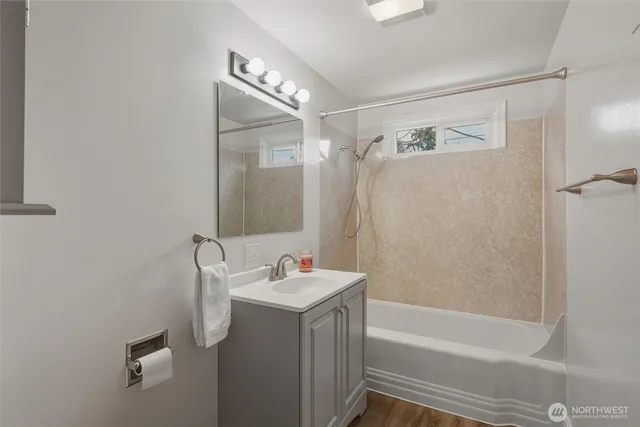 a bathroom with a sink mirror toilet and bathtub
