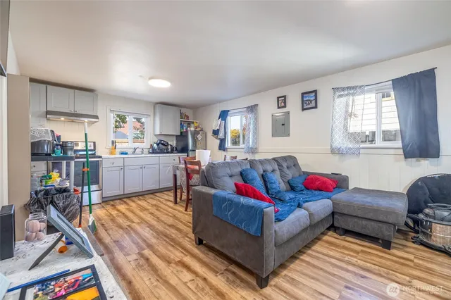 a living room with furniture and kitchen view