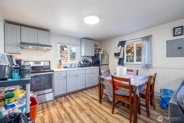 a kitchen with a dining table chairs and sink