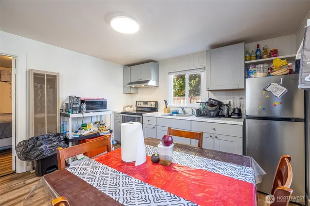 a living room with furniture a rug and kitchen view
