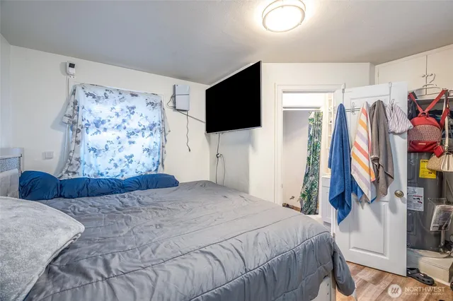 a bedroom with a bed and a flat screen tv